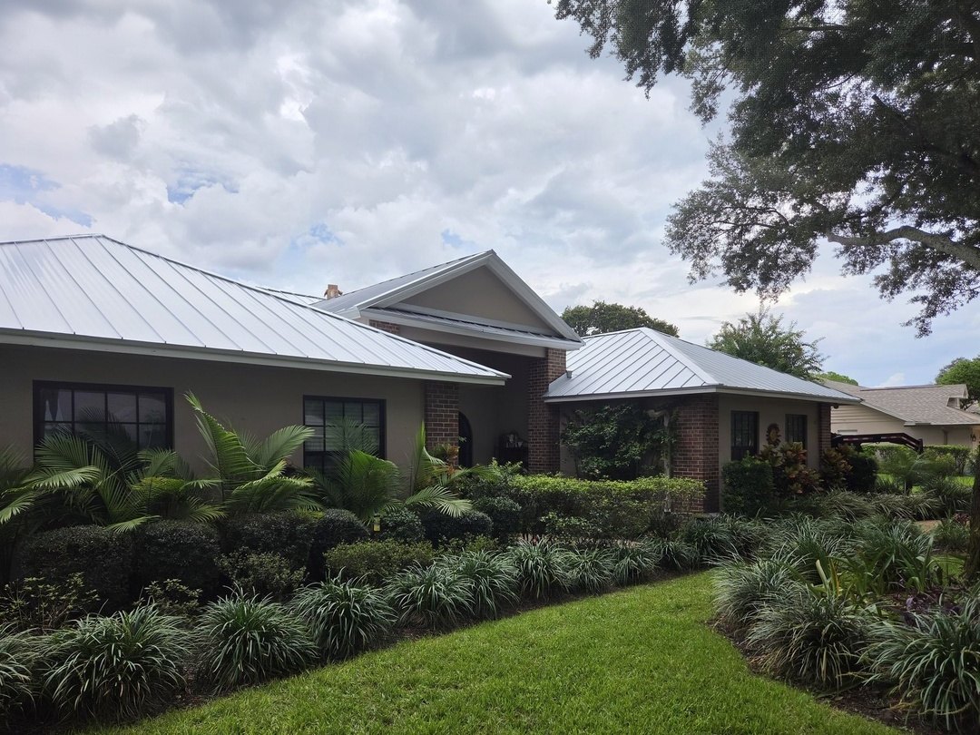 A home in Lutz with a new standing seam metal roof, seen from the front lawn