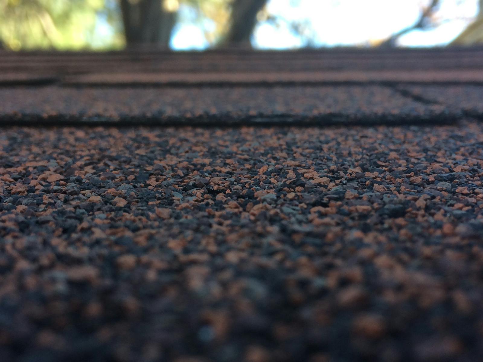Close-up of asphalt roof shingles showing the texture and layered detail of a quality roof install