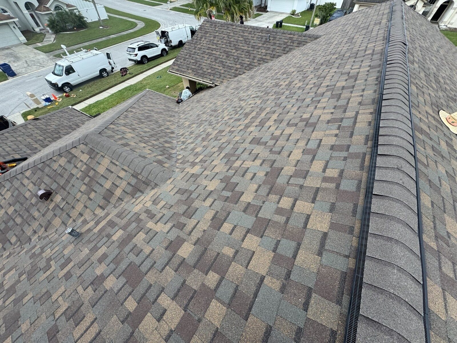 Finished roof, valley and hips, crew packing up at the curb on a shingle roof in Wesley Chapel