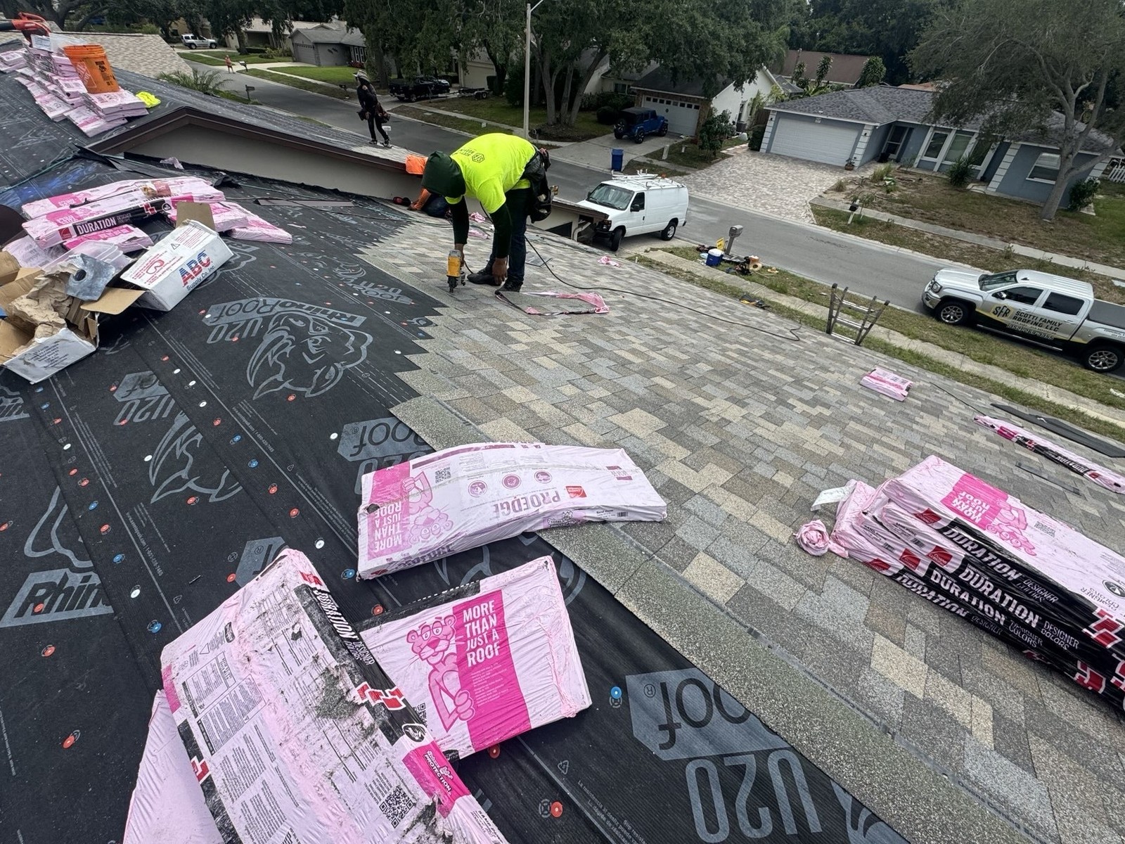 Roofing crew nailing shingles on a Palm Harbor reroof