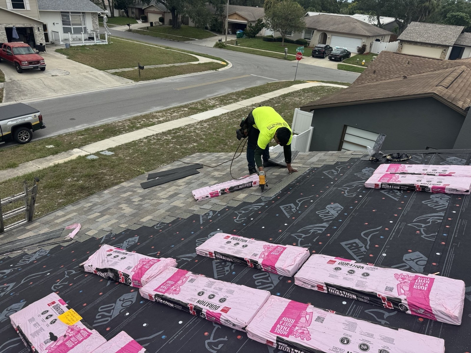 Asphalt shingle installation in progress on a Palm Harbor roof