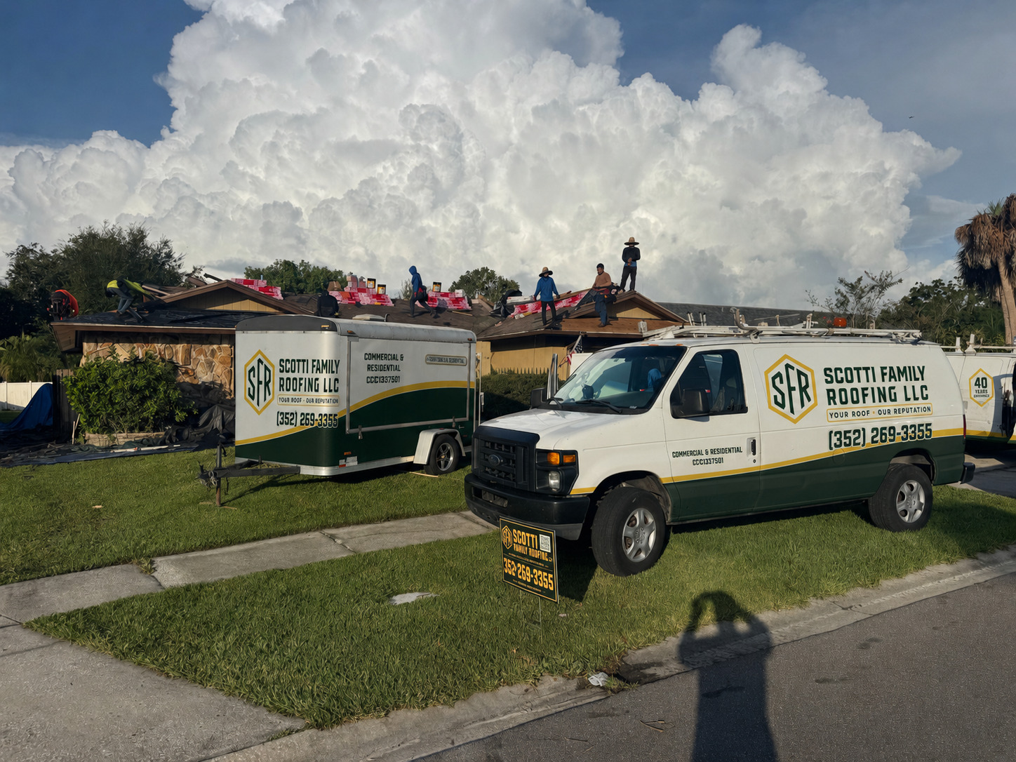 Scotti Family Roofing trucks parked at a Tampa FL home while the crew works on the roof