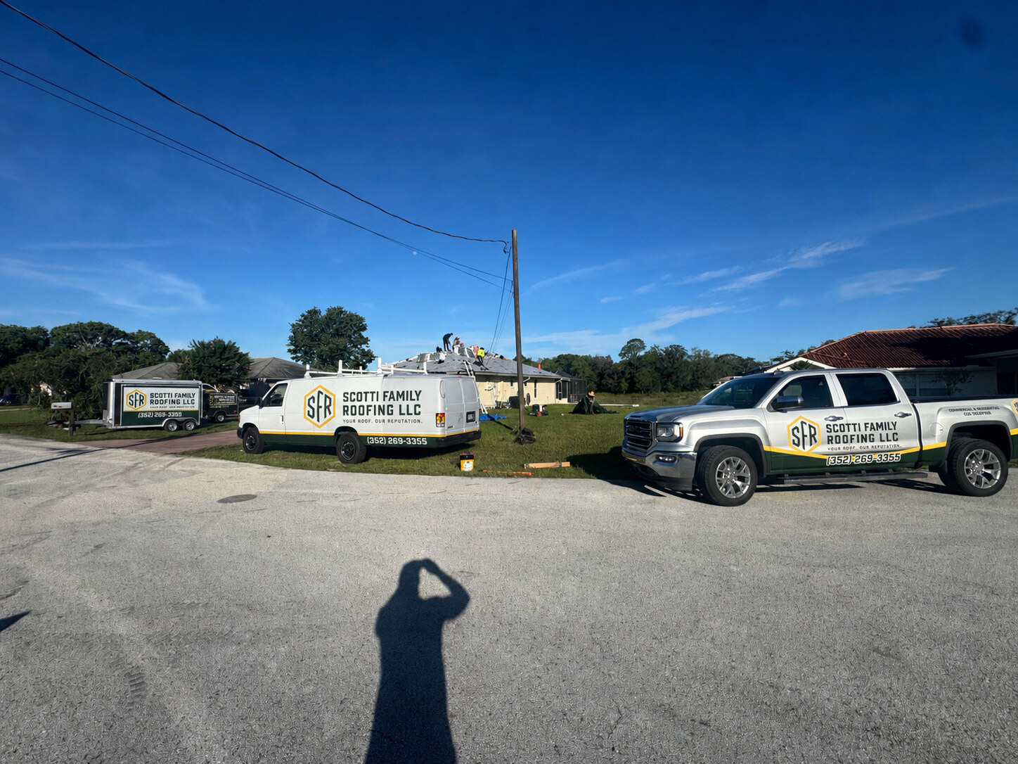Scotti Family Roofing branded truck and trailer staged outside a Spring Hill FL home on install day